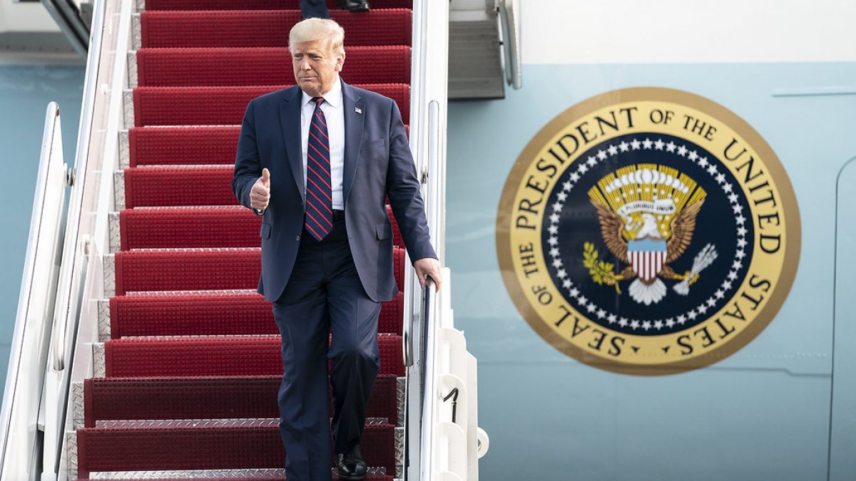 Donald Trump gives a thumbs up while walking down the Air Force One stairs