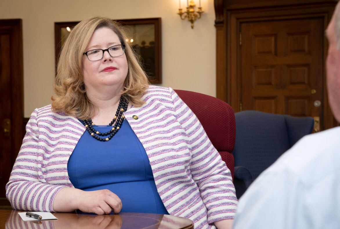 GSA Administrator Emily Murphy sits at a brown table