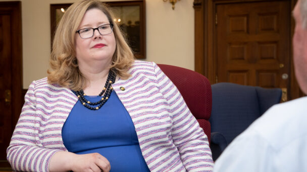 GSA Administrator Emily Murphy sits at a brown table