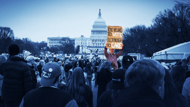 Image of femme protestor holding a sign that says "Too young too vote, old enough to care" in front of the Senate building. Image is tinted navy except protestor.