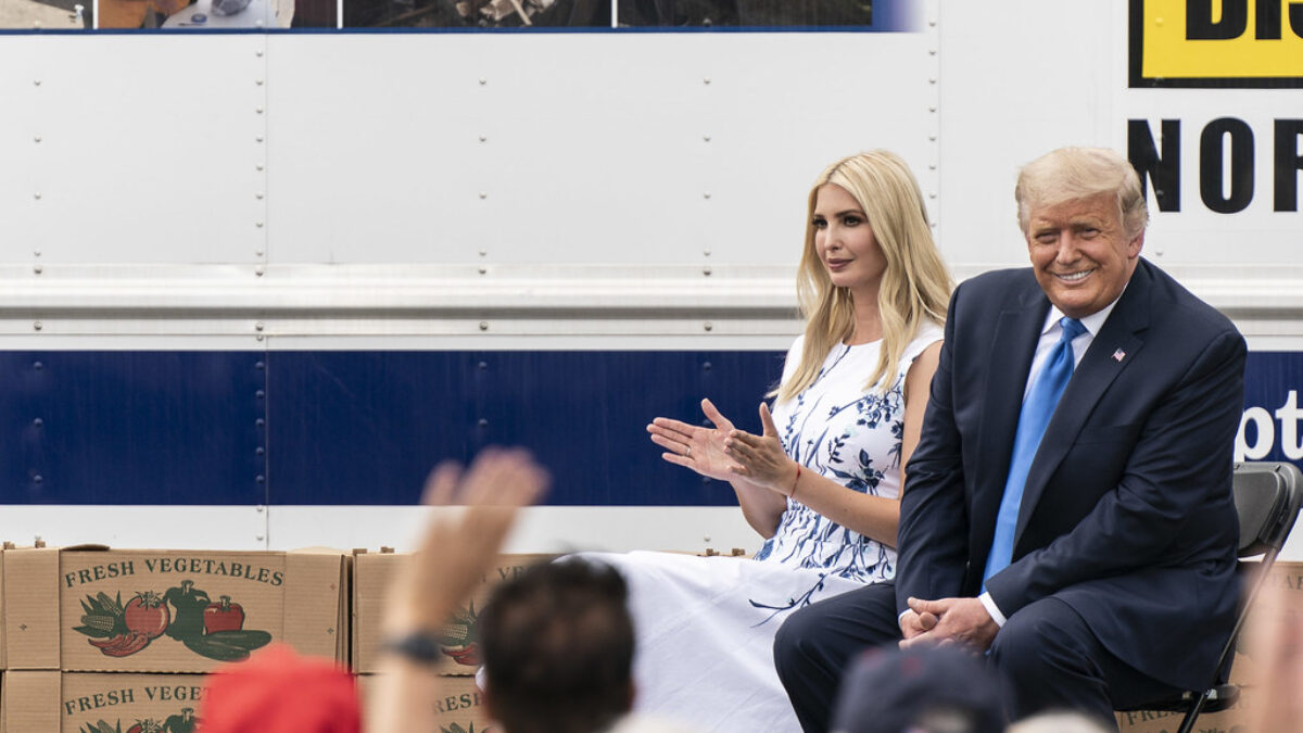 Ivanka Trump claps next to a smiling Donald Trump