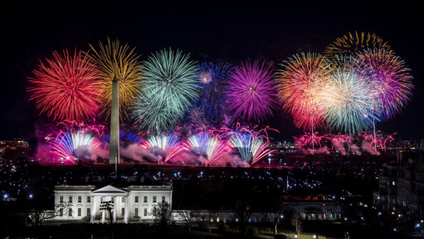 Rainbow-colored fireworks on the National Mall, behind the White House and Washington Monument