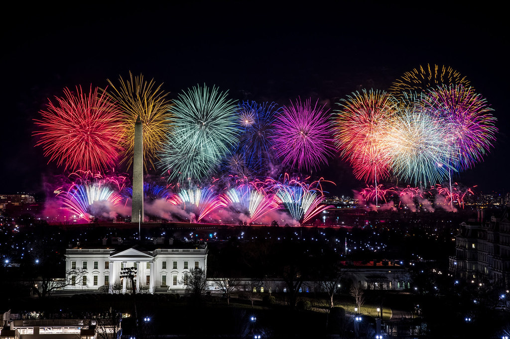 Rainbow-colored fireworks on the National Mall, behind the White House and Washington Monument