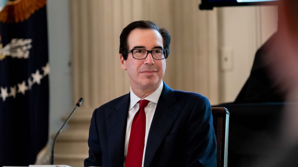 Steve Mnuchin sits at a table