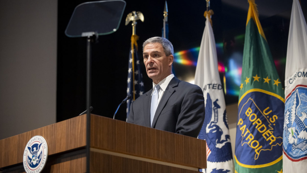 DHS official Ken Cuccinelli speaks at a podium