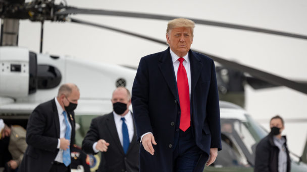 A stern-faced Donald Trump walks away from Marine One