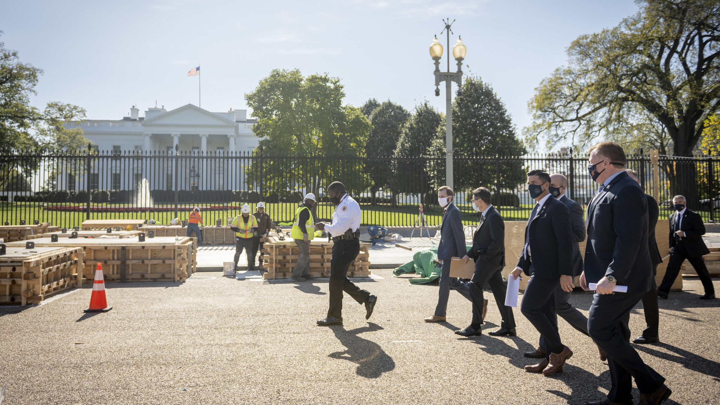 Secret Service walk past the White House