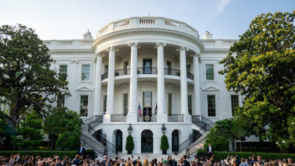Crowd gathers in front of the White House as Trump gives a speech.