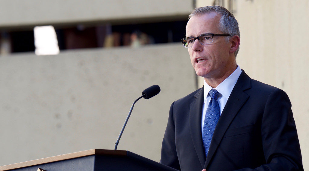 Andrew McCabe speaks at a podium