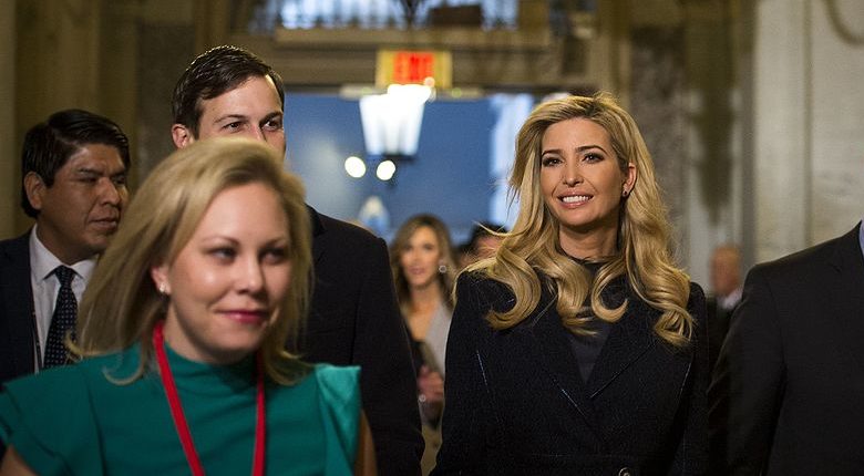 A smiling Ivanka Trump walks down a Capitol hallway with her husband Jared