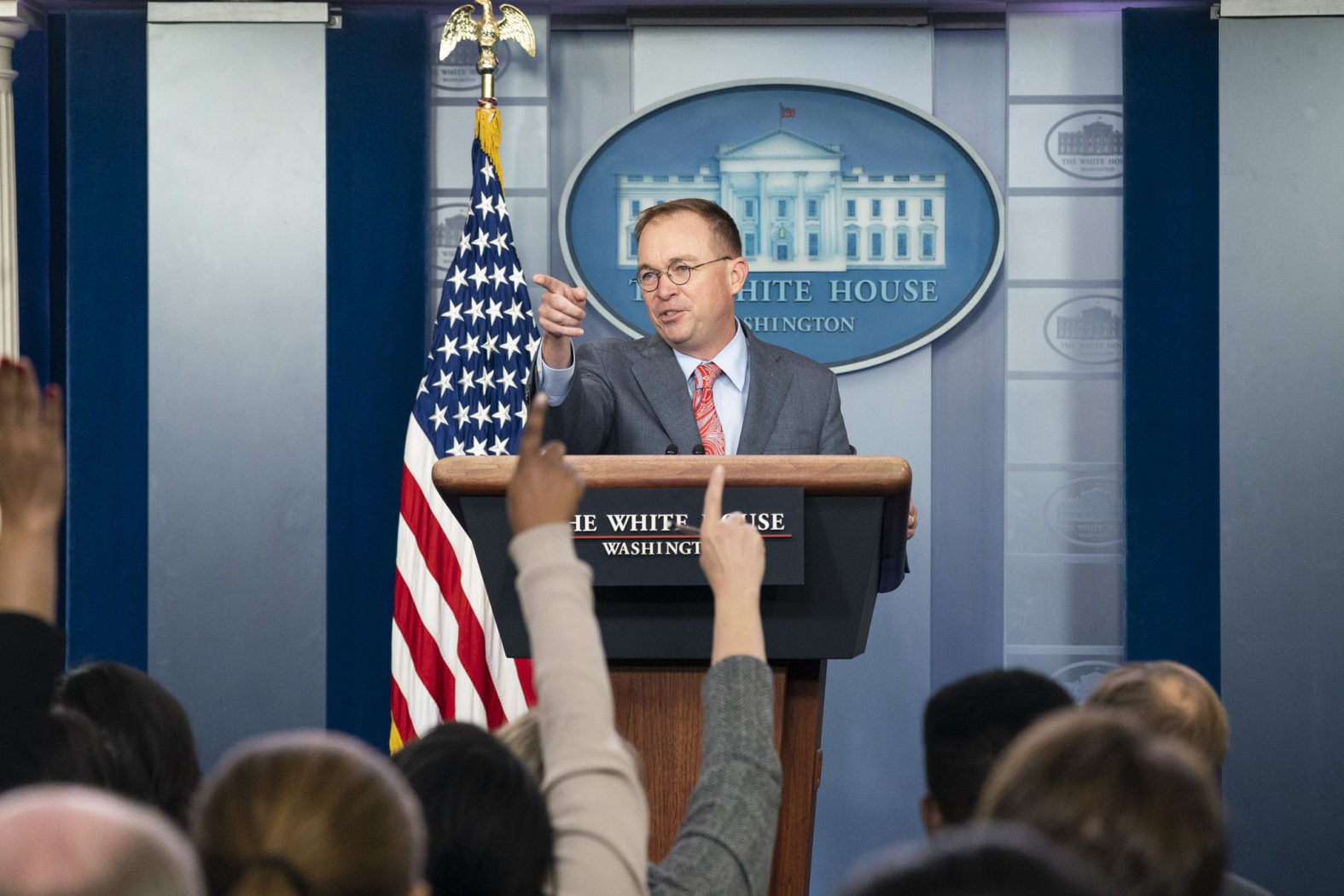 Mick Mulvaney calls on a reporter at a press conference