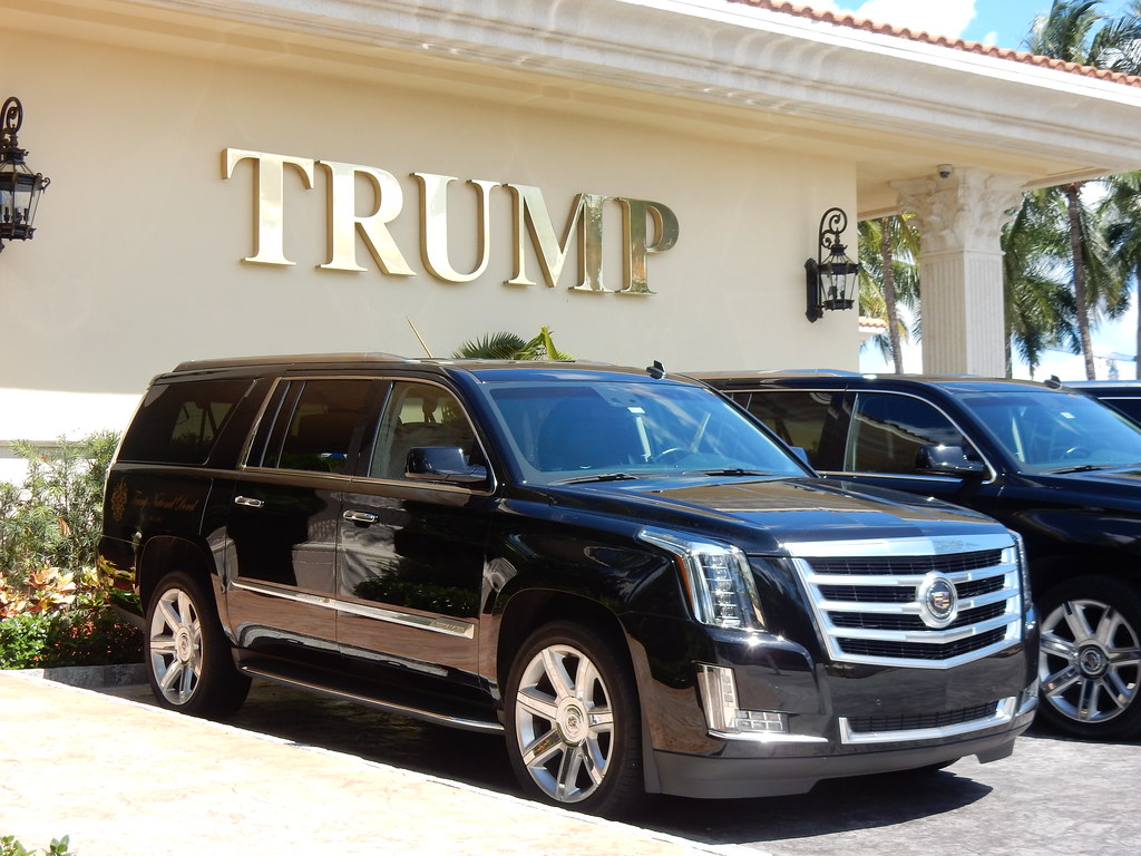 A black Cadillac SUV sits outside the Trump Doral hotel