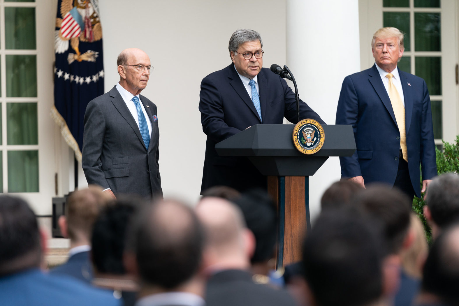 President Donald J. Trump, joined by Secretary of Commerce Wilbur Ross, listens as U.S. Attorney General William Barr delivers remarks Thursday, July 11, 2019, in the Rose Garden of the White House to expand on President Trump’s Executive Order requiring every department and agency in the federal government to provide the Department of Commerce with all requested records regarding the number of citizens and non-citizens in the United States. (Official White House Photo by Shealah Craighead)