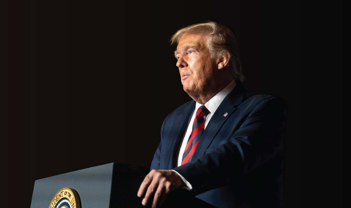 Donald Trump stands at a podium