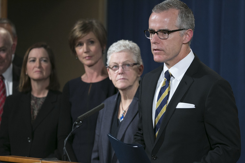 Andrew McCabe speaks at a podium at an event