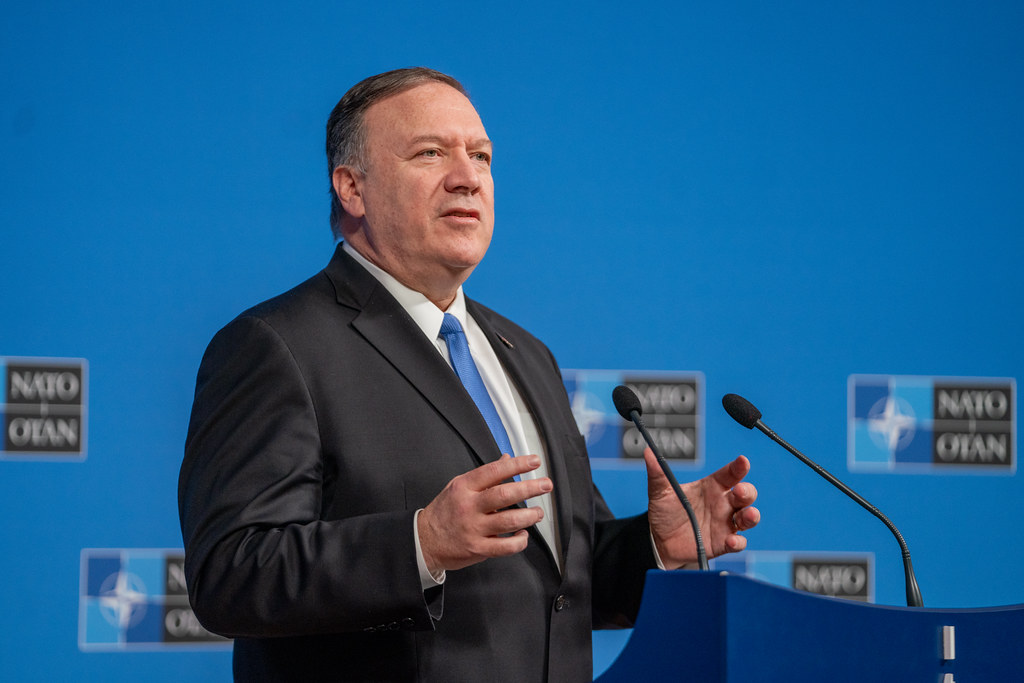 Mike Pompeo speaks at a podium at a NATO event