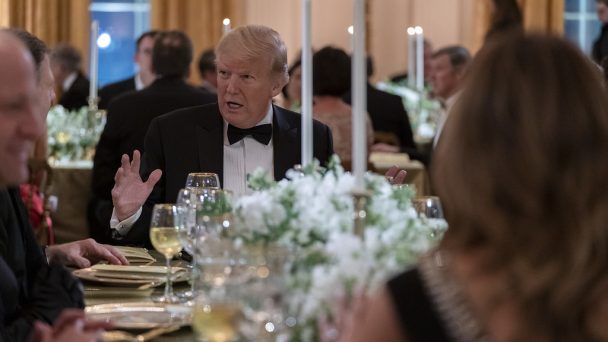 President Trump sits at formal dining table