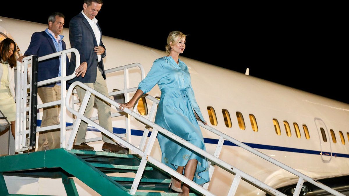 Ivanka Trump, in a flowing blue dress, walks down the steps of Air Force One