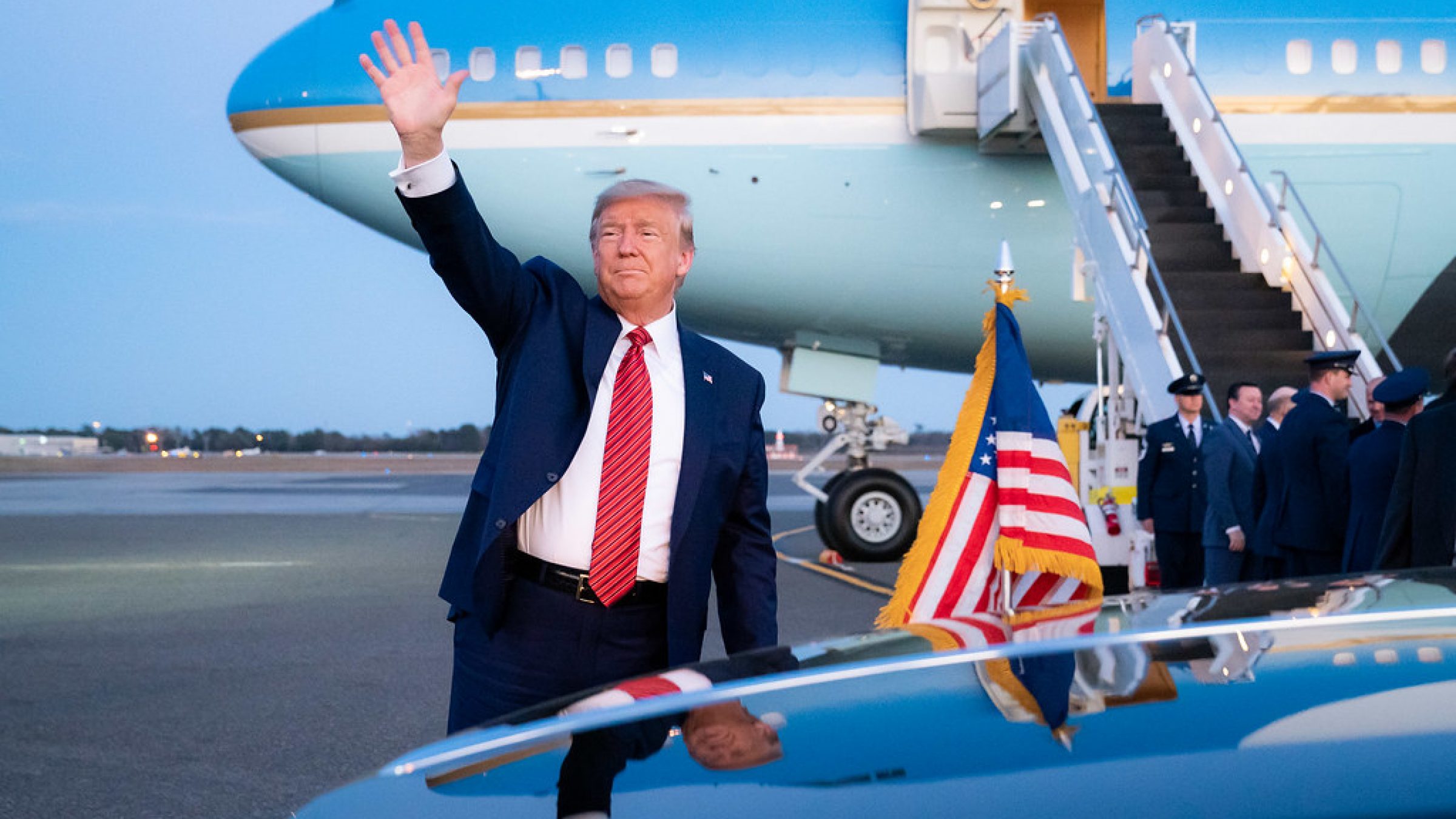 Donald Trump waves while near Air Force One